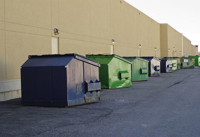 a row of yellow and blue dumpsters at a construction site in Beverly Shores, IN